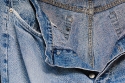 Well worn jeans trousers sundrying.